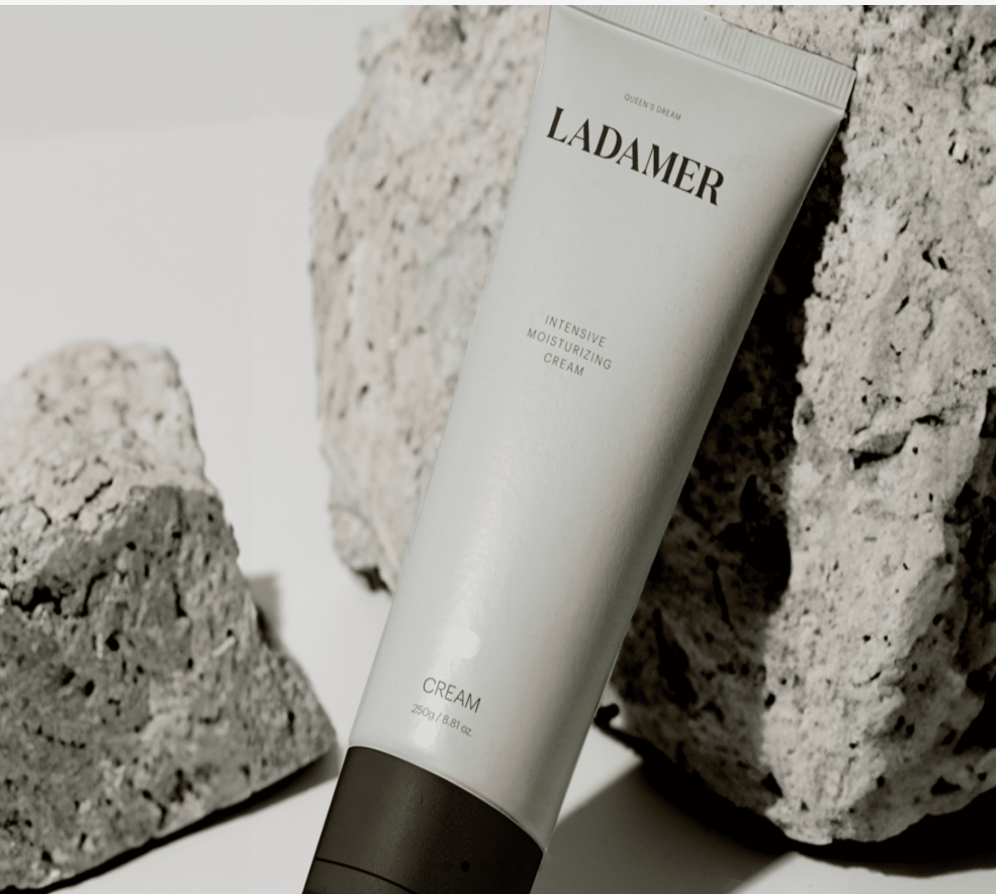 A minimalist product photo of Ladamer Intensive Moisturizing Cream on natural stone background, highlighting its spa-inspired premium design.